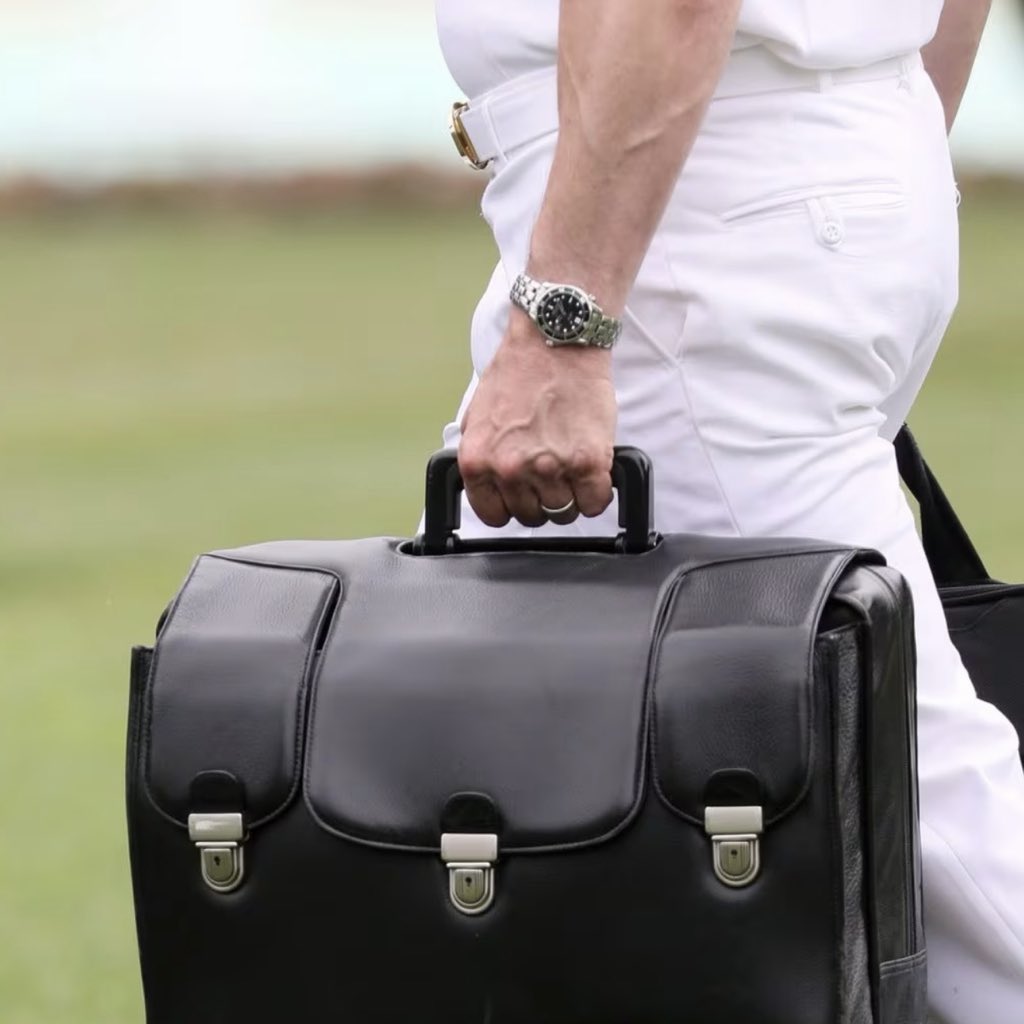 watchesofespion's tweet photo. Omega Seamaster on the wrist of the serviceman carrying the so called "nuclear football" while walking to Marine One.  Iconic shot. https://t.co/V6nQVYv7M8