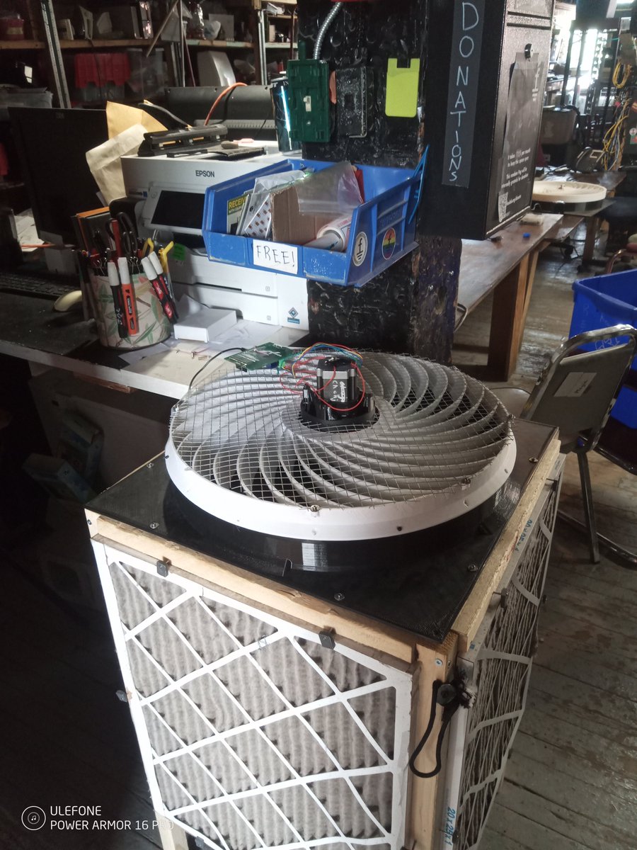 open_erv's tweet photo. I spent most of Sunday cobbling together a big quiet fan from old prototype parts.  This one has extra power.  It was installed at Foulab, where there is a lot of background noise (usually other fans in the computers).  Thus the extra noise from giving it some extra power is harmless.  

To allow it to put out extra power, I put the driver board upside down at the exit, the extra cooling allows extra power.  It has 4 redundant safety measures, one at the power supply for overcurrent, the driver chips themselves, stall detection in the motor driver microcontroller, and a final thermal fuse on the motor itsself.  You don't really need any of them but better to be safe, only two of them I deliberately arranged for, the others are just along for the ride.  Because it is cobbled together parts, and therefore not thoroughly tested, this is advisable.

I noticed when I dismantled the old fan that there was actually dust on the inside of the system.  I have added it to my list of things to do to check the output and input of they system to ensure that it is still removing particles the way we think it is, because the filters are pretty dirty.  The study by the CR box foundation found that the main source of CADR loss is reduced efficiency as the filters become dirty.

The air at Foulab really really needs the air purifier, it is very dusty and dirty. A lot of dust comes through the cracks in the ceiling (floorboards from the floor above are exposed) and elsewhere in the building.  We also often have fairly large gatherings and in winter there is no deliberate means of obtaining fresh air.

I would like to cobble together some TW4 parts to make an ERV of large capacity that could go in the window, but it would be a little expensive/time consuming.