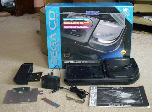 RetroEvery's tweet photo. Just unboxed a absolute '90s time capsule!   Sega CD complete in the original box — console, power brick, cables, mounting hardware, manual, the works. This bad boy is about to turn my Genesis into a full-motion video & CD-audio beast again.  Who else lived for the Sega CD era? Drop your favorite games or wildest memories below!   #SegaCD #RetroGaming #SegaGenesis
