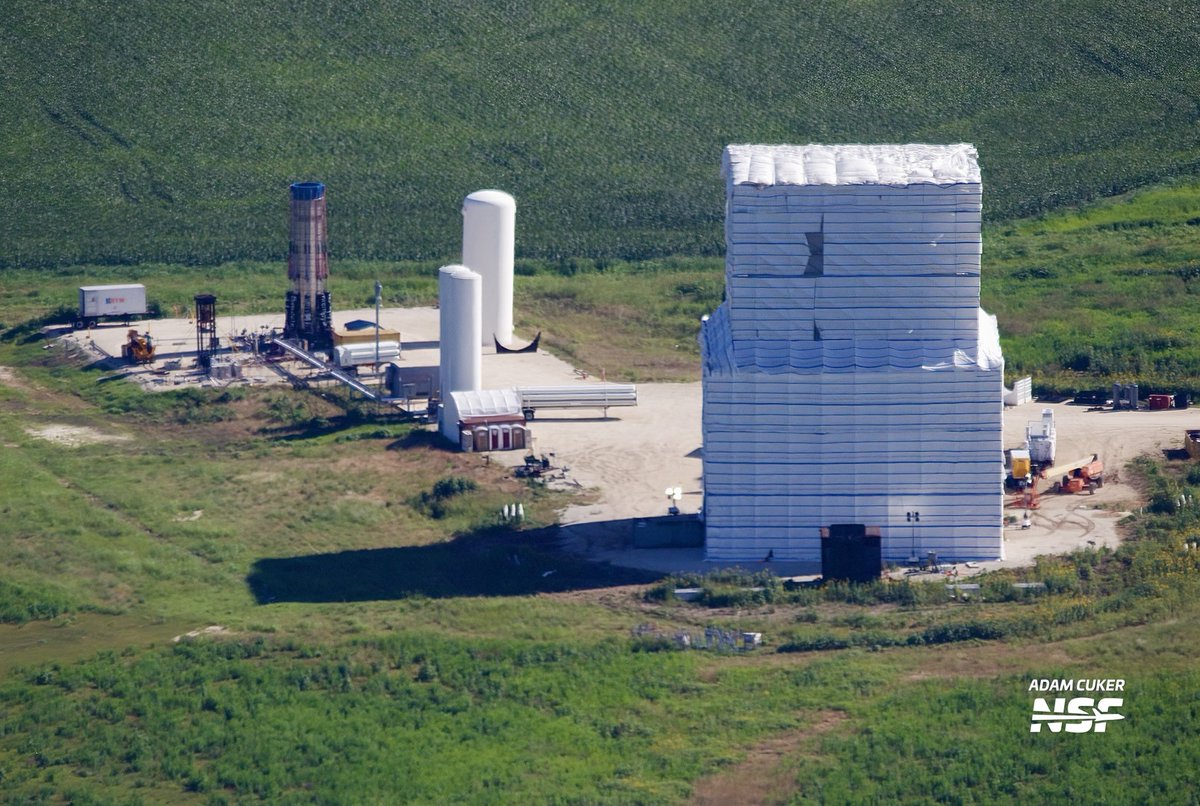 AdamCuker's tweet photo. SpaceX McGregor flyover yesterday with pilot @ClaudiusNDX. 

These photos show the new buildings under construction near the front entrance, along with component testing areas and a wrapped Stage 1 booster and multiple Stage 2’s parked outside. 

@NASASpaceflight https://t.co/hS4K1WYBlC