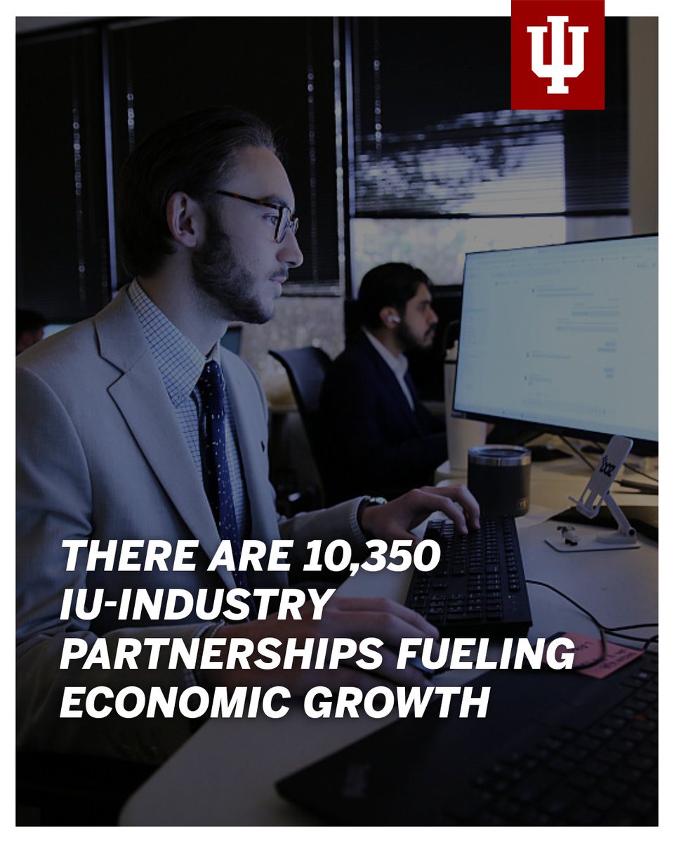 Two people are working at desks with computers in an office setting. An Indiana University logo is in the top right corner. The text on the image reads, "There are 10,350 IU-industry partnerships fueling economic growth."