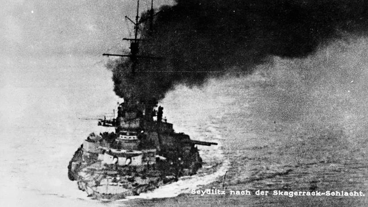 HiddenHistoryYT's tweet photo. 110 years ago today, the most battered warship in history limped home from the largest naval battle the world had ever seen. By every law of physics, she should have been dead. The reason she lived is one of the strangest stories of WW1.

This is the SMS Seydlitz.

To understand the miracle of June 1, 1916, you have to go back 16 months.

January 1915, the Battle of Dogger Bank. A British 13.5-inch shell from HMS Lion smashes into the rear of the Seydlitz and punches through the barbette of her aft turret. What happens next is every battleship sailor's nightmare. The blast ignites the cordite charges in the loading chamber, and a wall of fire flashes downward toward the magazines, where tons of high explosive sit waiting.

159 men die in seconds. Both aft turrets are gutted.

The ship is heartbeats away from being vaporized.

And then one man saves her. Pumpenmeister Wilhelm Heidkamp fights through the smoke to the flooding valves for the magazines. The valves are already glowing red hot from the fire. He turns them anyway, with his bare hands, flooding the magazines and drowning the explosion before it can reach the rest of the ship. He is horribly burned. The Seydlitz survives.

The Germans learn the lesson the British do not. They redesign their entire ammunition system: anti-flash doors in the hoists, tighter control of how much cordite sits exposed, ruthless discipline about propellant handling. The British shrug it off. That difference will get three British battlecruisers blown to pieces at Jutland a year later.

Now, June 1916.

At Jutland, the Seydlitz becomes the most shot-at ship in the battle. She is hit TWENTY-ONE times by heavy-caliber shells. A torpedo tears into her hull. A shell punches into the working chamber of a turret and sets it ablaze, and this time, because of the Dogger Bank reforms, the fire does NOT reach the magazines. The thing that should have killed her had already killed her once, and the Germans had built the cure.

But the damage is apocalyptic. She drinks in more than 5,300 tons of seawater. Her bow sinks so low that the only buoyancy left in the entire front half of the ship is one flooded torpedo room. Her freeboard drops to a couple of meters. She is, functionally, a submarine that hasn't finished sinking yet.

The journey home is a slow-motion nightmare. She lists 8 degrees with almost no stability left. She can barely make 3 knots. At times she has to travel STERN FIRST, sailing backwards across the North Sea, because her crushed bow can't take the waves head on. Pump steamers come alongside and breathe for her. A tug lays an oil slick to calm the sea. The crew prepares to abandon ship more than once.

And somehow, she makes it. She reaches the outer Jade river on June 2 and crawls into the Wilhelmshaven lock on June 3, so low and so flooded she has to be physically lightened just to clear the bar.

Sailors started calling her "the shell magnet." She had absorbed enough punishment to sink a small fleet, and she came home.

Here is the part that gives me chills.

Wilhelm Heidkamp, the burned pump master who saved her at Dogger Bank, was never forgotten. Decades later the German navy named a warship after him: the destroyer Z21 Wilhelm Heidkamp. In 1940 that destroyer led the German assault on Narvik, where it too was hit, exploded, and sank. The man who once drowned a magazine to stop an explosion gave his name to a ship that died by one.

Learn more here: https://t.co/eLFC0f5NCr