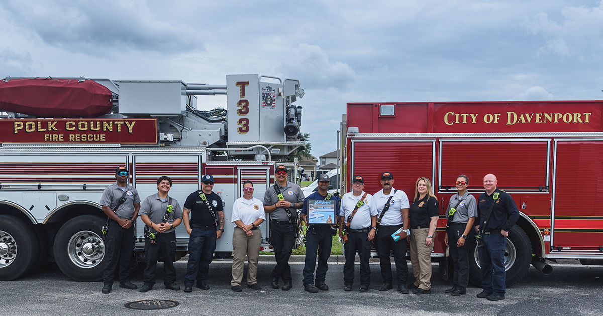 PolkFire's tweet photo. Polk County Fire Rescue and Davenport Fire Department members came together to help the community during Water Safety Month. The members spoke with residents about pool safety and provided free pool alarms, door/window alarms and educational material. https://t.co/Egp471QyNg