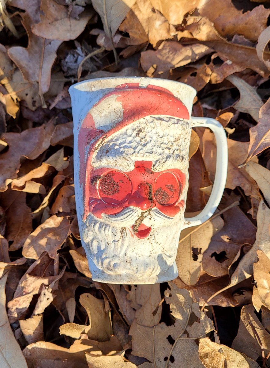 cfeagans's tweet photo. Fun artifact: This plastic 1950s/1960s Santa Claus mug used to have Vari Vue eyes that followed you as you moved the mug. Just sitting in the leaves for decades, left behind so many Christmases ago. https://t.co/EiIWwMu9dK