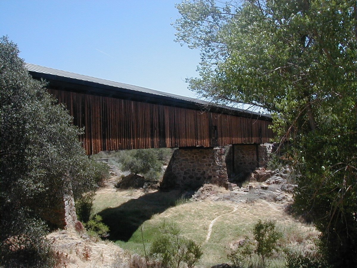 Cartel_Cal's tweet photo. Knights Ferry Bridge, Knights Ferry California. Built in 1863 crossing the Stanislaus river during the gold rush it remains the longest covered bridge west of the Mississippi. Closed to vehicles in 1981 and has since became an historic landmark. Photo taken in 2002. #CalHistory https://t.co/dmJNk58xgk