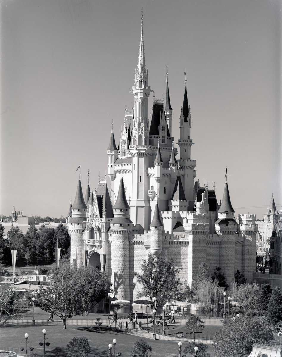 JLHomni's tweet photo. In stark contrast to all the AI detractors, these new tools can help breathe new life into the images of our past, as in this colorization of an iconic B&amp;W photo of Cinderella Castle in all its 1974 glory as it towers over the spartan foliage of a young Magic Kingdom. https://t.co/s3nGpKV3RH