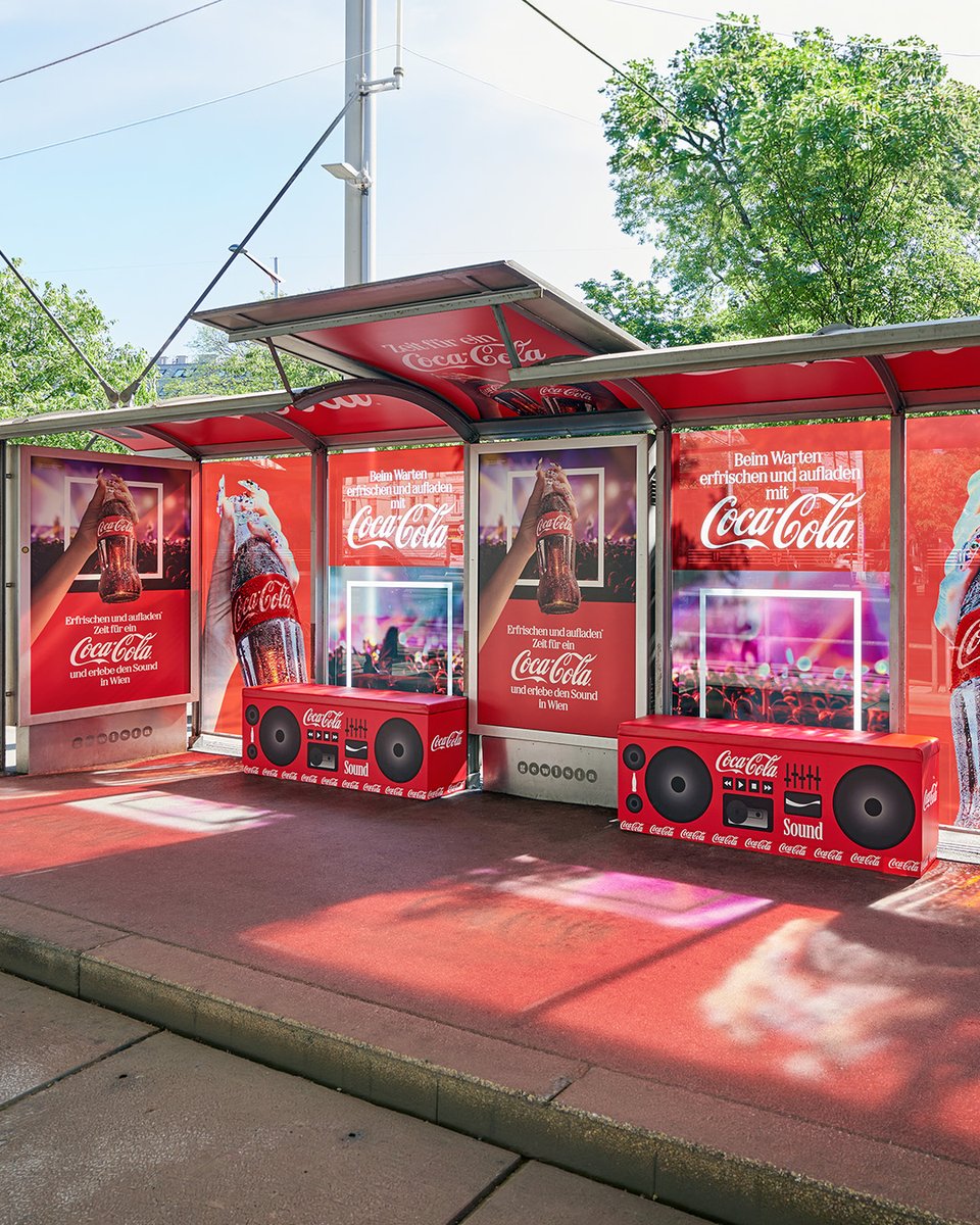 JCDecauxGlobal's tweet photo. To celebrate the Eurovision Song Contest, a Gewista bus shelter was transformed in partnership with @CocaCola: a full red wrap, branded interior arches and bench seating styled like boom boxes. A head‑to‑toe look that brought music right from the pavement! ✨🎶🎧 https://t.co/BM48h5cyP5