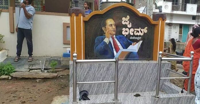 HateDetectors's tweet photo. A tense situation prevailed in Masanapura village near Chamarajanagar on Sunday after a youth allegedly desecrated a portrait of Dr B.R. Ambedkar installed along the village’s main road.

The incident triggered public outrage, leading to protests and the deployment of additional police personnel to maintain law and order.

According to sources, the incident occurred at around 5 am when Chandru (19) allegedly desecrated the portrait of Dr B.R. Ambedkar, a revered social reformer and principal architect of the Indian Constitution.

Residents who witnessed the act reportedly confronted the youth and tied him to an electricity pole before assaulting him.

As information about the incident spread across the village, tensions escalated and a large number of residents gathered at the spot.

Police personnel rushed to the area and rescued the youth from the crowd before shifting him to safety.

Authorities responded swiftly to the situation to prevent further disturbances. Senior police officers visited the village and assessed the law-and-order situation following the incident.

Police officials increased security arrangements in and around the village as a precautionary measure. Additional personnel were deployed to ensure peace and prevent any untoward incidents.

The youth was taken into police custody for questioning, and an investigation was initiated to ascertain the circumstances surrounding the alleged act.

Following the incident, villagers organised a protest demanding strict action against those responsible. Protesters sought justice and urged authorities to conduct a thorough investigation into the matter.

Many residents expressed anger over the alleged desecration, emphasising the significance of Dr Ambedkar’s contributions to social justice, equality and constitutional governance.

The protest drew the attention of local leaders and public representatives, who arrived at the village to engage with residents and help restore calm.

Among those who visited the village was A.R. Krishnamurthy, who held discussions with residents and appealed for peace. He, along with other leaders, urged villagers to cooperate with the authorities and allow the investigation to proceed through legal channels.

Following assurances from officials and public representatives, the protesters agreed to withdraw their agitation. However, police continued to maintain a strong presence in the village to prevent any further tensions.

Officials have stated that all aspects of the incident will be investigated and appropriate legal action will be taken based on the findings of the inquiry.

Police are collecting statements from witnesses and examining evidence related to the incident. Authorities are also investigating whether there were any additional factors or individuals involved.

Law enforcement agencies have appealed to residents to maintain communal harmony and refrain from spreading rumours that could aggravate the situation.

The incident has once again highlighted the sensitivity surrounding acts involving national leaders and public symbols, prompting authorities to remain vigilant while ensuring that the matter is addressed through due legal process.