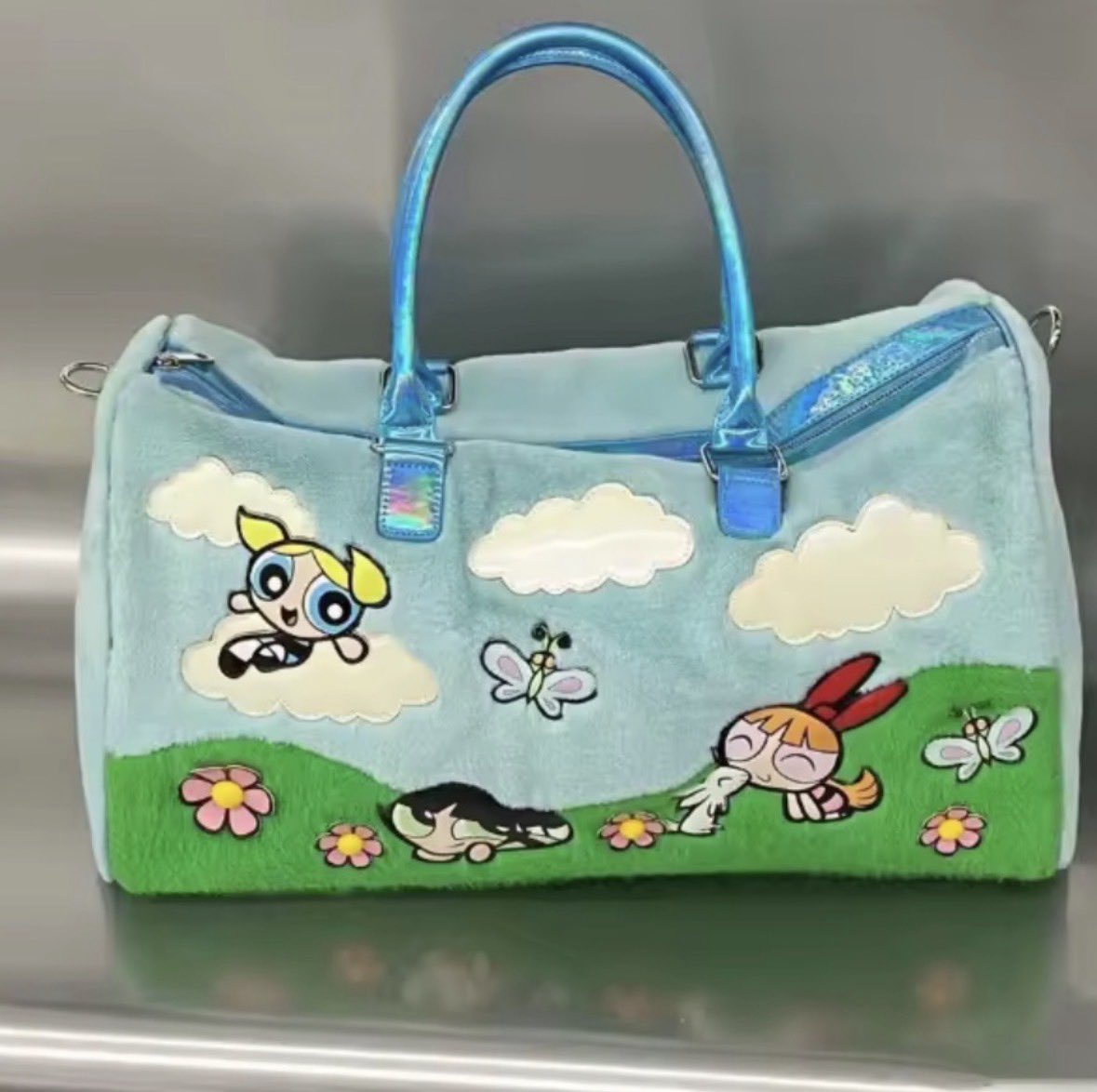 JillianValentin's tweet photo. Saw this 2023 dolls kill collection powerpuff girls 25 year celebration bag on a resell sight and was like why does it remind me of something…. 
Pudgy

I’m not shading pudgy I own pudgys and love them, but the design team 😬 they could have at least said it was inspired by. Idk https://t.co/YblFEyaadC