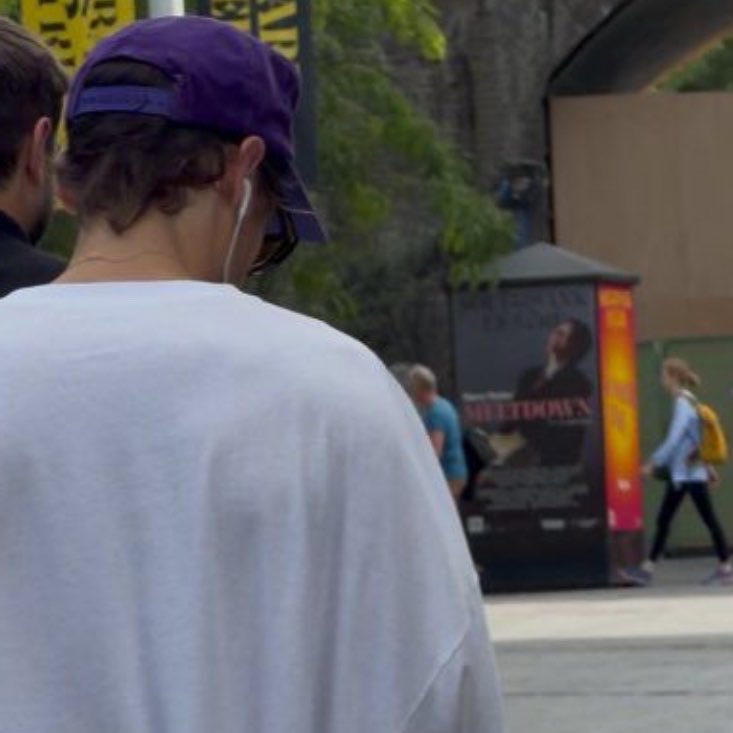 axlsugar's tweet photo. harry styles walking past the ‘meltdown festival’ poster like he isn't literally the curator…  main character energy https://t.co/FFCOcLpSAk