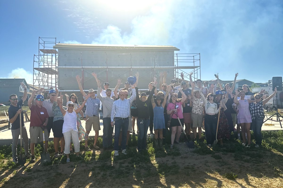Community members and Councilmembers at the Habitat for Humanity at Bloom groundbreaking event, celebrating together, smiling with their arms in the air 