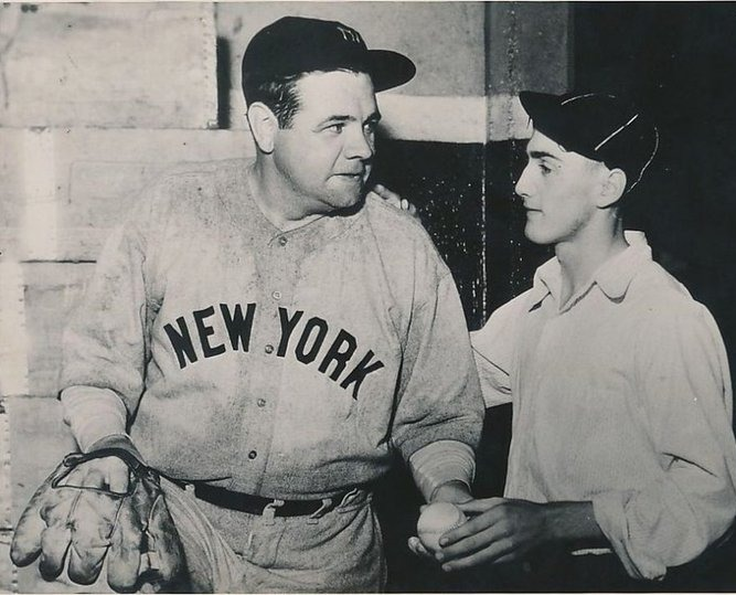 Jimfrombaseball's tweet photo. "In the 3rd inning at Navin Field in Detroit, Babe Ruth wallops a Tommy Bridges 3-2 pitch far over the right field wall and on to Plum Street for his 700th career home run.
It was estimated the ball travelled 500 feet when Ruth connected in the third inning, and Babe immediately started screamed out loud to Yankee third base coach Art Fletcher:
“I want that ball!
I want that ball!
Bring whoever caught it around to the clubhouse and I’ll give him twenty dollars.” “I was waiting for a friend who was late. Suddenly a cry rang down Trumbull from the bleachers Of Navin Field:
‘The Babe socked one!’
I was just standing nonchalantly out there and saw the ball coming over the fence and straight down Plum Street.
Me being a track man at Northwestern High School, I went down the street after it, like a nine-second man.
It rolled under a car.
I dove under the car and grabbed it.
Then a lot of policemen and ushers all grabbed me.
They put me on their shoulders and stopped the game and took me into the ballpark and put me in the dugout with Babe Ruth, Joe McCarthy the manager and Lou Gehrig.
After the game, Babe said:
‘I’m gonna give him $120.’
Babe Ruth didn’t have his wallet though, so he told Lou Gehrig:
'I’ll give that boy a $20 bill.'"
17 year old Lenny Bielski.
In the clubhouse Ruth did in fact give Bielski twenty dollars and an autographed baseball in exchange for the home run ball, making Bielski very happy.
The Babe said:
"That’s a ball I’ve wanted for a long time."
Lou Gehrig took Bielski aside later and said, “If you’d been a little older, you’d have got thousands of dollars for it.”
Gehrig told Bielski that the man who caught Ruth’s 600th home run hit in St. Louis:
"Got $4,000 or $5,000 for that ball."
Babe Ruth and Lenny Bielski.