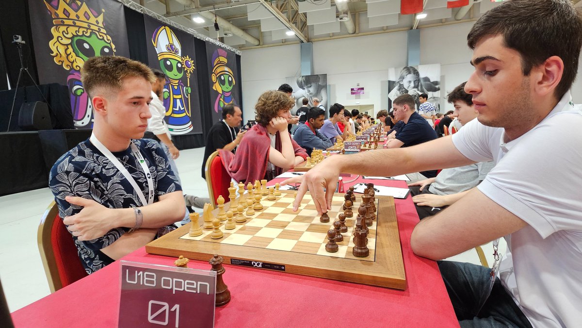 ChessbaseIndia's tweet photo. Round 2 of the FIDE World Youth Chess Championships 2026 got underway today at the Pala Dean Martin Congress Center in Montesilvano, Italy.
The ceremonial first move was made by Luigi Maggi, President of the Italian Chess Federation, on Board 1 of the Girls Under-18 section, featuring top seed WIM Zarina Nurgaliyeva against Alexandra Grebeniuc.

Here are some moments from the start of Round 2.
@FIDE_chess @GM_Mogranzini 
📸 Niklesh Jain / ChessBase India
♟️ FIDE World Youth Chess Championships 2026