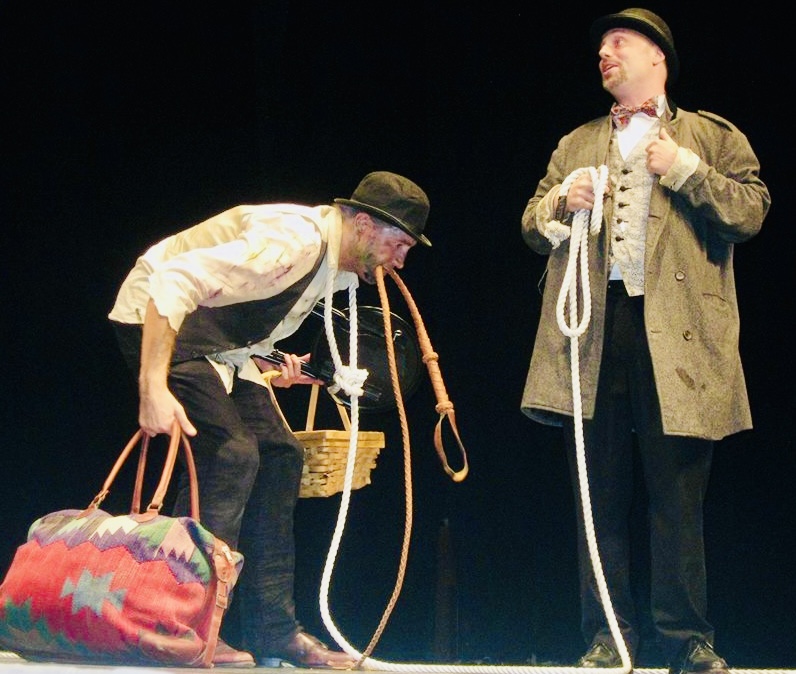 TBTBTheater's tweet photo. “TAKE THIS JOB AND SHOVE IT!” An exceptional production of “Waiting for Godot” directed by Pamela Sabaugh! #SamuelBeckett #PamelaSabaugh #FredBackus #DavidRosarStearns #Slavery #TBTB
Image description: (left) Lucky (David Rosar Stearns) hunched over, dressed in raggedy clothes, carrying heavy bags, being led with a rope in his teeth by Pozzo (Fred Backus), standing proudly, dressed in clean, more expensive clothing.