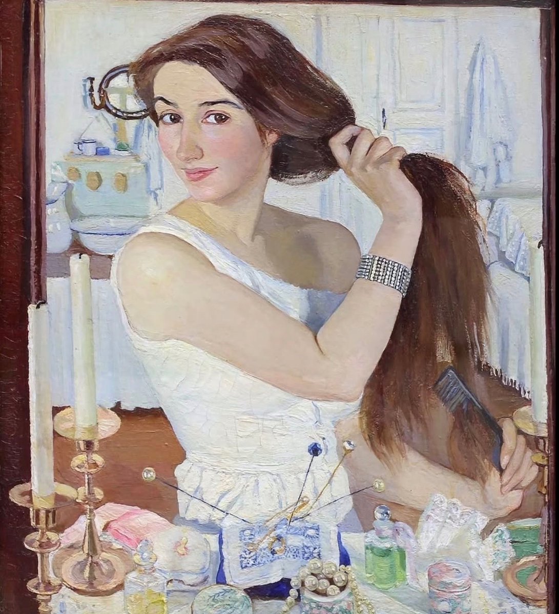 historyinmemes's tweet photo. This is a painting from 1909.

Zinaida Serebriakova’s At the Dressing-Table (Self-Portrait) is a 1909 oil-on-canvas masterpiece painted when the artist was just 25 years old. Snowed in at her family’s estate near Neskuchnoye—then part of the Russian Empire and now in Ukraine—Serebriakova found herself without access to models or travel, so she turned the brush on herself. Using her reflection in a mirror, she captured a quiet domestic scene surrounded by the everyday items on her dressing table.

What makes the painting feel so strikingly contemporary is its warmth and spontaneity. Rather than presenting a formal, distant portrait, Serebriakova smiles directly at the viewer while brushing her hair, creating an intimate, candid moment that feels surprisingly modern for 1909—almost like a snapshot taken on a smartphone a century later. Today, the painting remains one of her most beloved works and is housed in the Tretyakov Gallery.