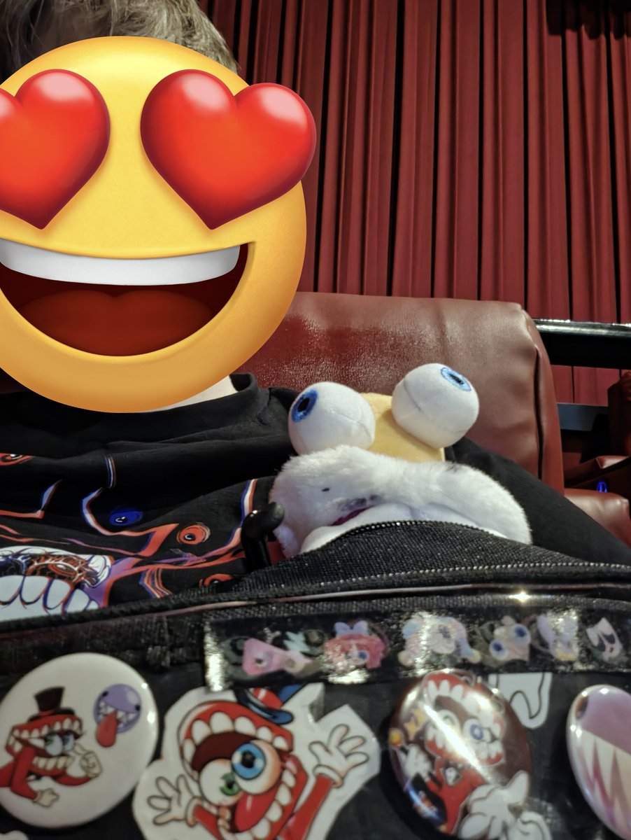Gryphy18's tweet photo. Went to the theater with Caine itabag, God Caine shirt, and his Dad plushie.

TADC The Last Act was great!  No spoilers, but the audience was crying, laughing, and cheering! https://t.co/ON16PlvgJN