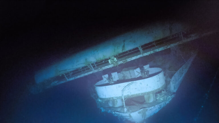 HiddenHistoryYT's tweet photo. Yorktown should not have been at Midway at all. A month earlier at Coral Sea, a Japanese bomb had torn through her decks, and the estimate to fix her ran to 90 days. Japan crossed her off as sunk. Admiral Nimitz gave Pearl Harbor's shipyard 72 hours. Some 1,400 workers swarmed her around the clock, welders still aboard as she steamed out to the ambush. Her presence at Midway was itself a kind of resurrection. She would need two more.

On the morning of June 4, her air group earned its keep: her dive bombers destroyed Soryu, and her torpedo squadron's sacrifice helped pull the Japanese fighters out of position for the killing blow. But by midday, one Japanese carrier was left alive. Hiryu, under the ferocious Admiral Yamaguchi, found Yorktown first.

The first strike came around noon: dive bombers, eighteen launched, most shot down on the way in, but three bombs got through. One burst near the island, one went down the smokestack and knocked out five of her nine boilers, one punched through the flight deck. Dead in the water and burning, she should have been finished.

She wasn't. Her damage control crews patched the deck with timbers and steel plate, relit the boilers, and within two hours she was making 19 knots and refueling fighters. The repair was so complete that when Hiryu's second strike arrived, the Japanese pilots reported attacking a different, undamaged carrier. Japan would end the battle believing it had knocked out two American carriers. It had hit the same unkillable ship twice.

That second strike was led by Lt. Joichi Tomonaga, whose plane's left fuel tank had been shot through that morning over Midway and could not be refilled. He led the mission anyway, knowing it was one way. His torpedo bombers bored in through everything Yorktown's escorts could throw at them, and two torpedoes slammed into her port side, jamming the rudder and cutting all power. Tomonaga did not return. Yorktown rolled into a 26-degree list, and with capsizing looking imminent, Captain Elliott Buckmaster gave the order no captain wants to give. The crew went over the side in good order. American doctrine, unlike the Japanese tradition that kept captains on burning bridges, expected Buckmaster to live; he left the ship last, sliding down a line into the sea.

And still she floated. All night, all the next day, the list never worsened. So on June 6 Buckmaster came back with a hand-picked salvage crew, the destroyer Hammann lashed alongside providing power, and they began to win: fires out, the list reducing, a tow rigged. Yorktown was coming home a third time.

Then, that afternoon, the Japanese submarine I-168, having slipped through the destroyer screen after a patient day-long approach, fired four torpedoes from inside the escort ring. One broke Hammann in half; she sank in four minutes, and as she went down her own depth charges detonated, killing men in the water. About 80 of her crew died. Two more torpedoes hit Yorktown.

Even then she refused to go quickly. She lingered through the night, and at dawn on June 7 the men on the surrounding destroyers stood at attention, ships' flags at half mast, as she rolled onto her port side and sank into three miles of water. The battle had ended days of fighting with a strange symmetry: four Japanese carriers and one American, all on the same patch of ocean floor.

In May 1998, Robert Ballard, the man who found the Titanic, found her: upright, intact, her guns still trained skyward, her hull number still visible, three miles down and almost untouched by time.