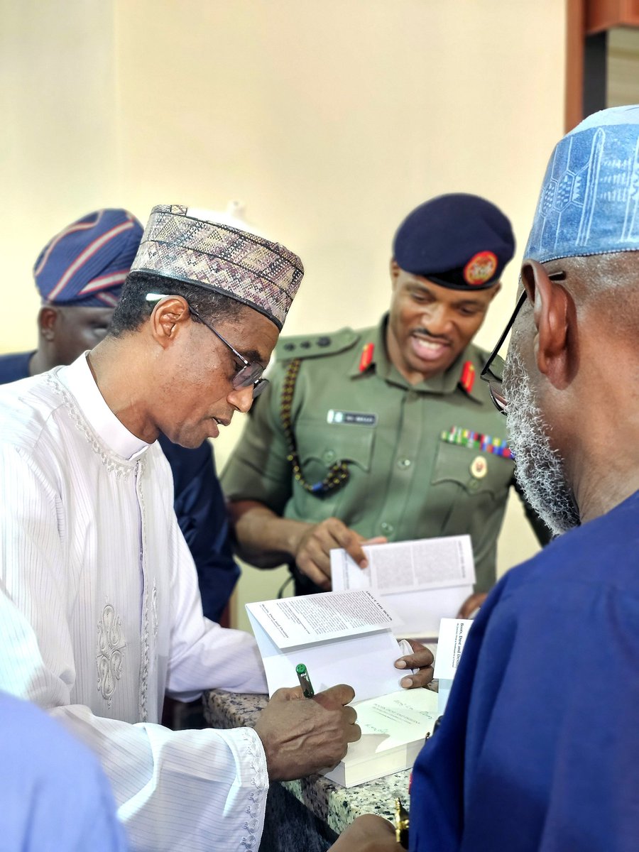 Gimbalanke's tweet photo. Maj. Gen. Abubakar Adamu (rtd.) signing a copy of his book, Boots, Dust and Destiny: My Journey from a Herdsman to a Military General, during the official launch of the book at the Nigerian Army Resource Centre, Abuja, on 26 March 2026.

#herdsmen #nigerianarmy https://t.co/9pLsDiCR3o