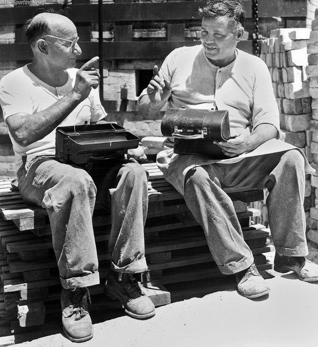 Jimfrombaseball's tweet photo. "It was during their lunch hour.
I gave my Dad the money and said:
'Pop, this is for you.
You won’t owe anybody anymore.’
I never saw my father cry but that day he did."
16 year old Joe Garagiola gives his Dad his signing bonus to pay off their mortgage.
"Working Class."
Pietro Berra, left, father of New York Yankees catcher Yogi Berra, and Giovanni
Garagiola, father of St. Louis Cardinals catcher Joe Garagiola, eat lunch at the St. Louis plant where they work. 1947.
Yogi’s father, Pietro, had come to United States alone in 1909 from Malvaglio.
Temporarily leaving his wife, Paolina, and two firstborn children in Italy, Pietro arrived through Ellis Island alongside thousands of other immigrants from across Europe.
After a brief stay in New York City, Pietro settled in St. Louis, his wife and children following him there soon after.