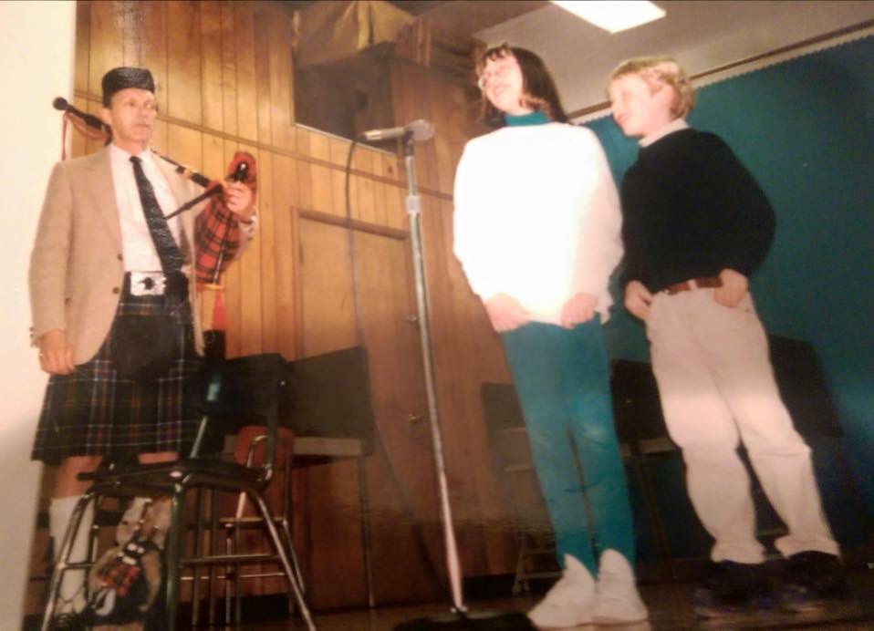 ClaireMax's tweet photo. I was looking for photos of my younger brother because it is his 36th birthday (insane), and I found this pic of me and my brother introducing my dad for a bagpipe performance at my elementary school in 1997. 

I always thought my dad playing the bagpipes was so cool and badass because not only did it celebrate our Scottish heritage, but it’s also REALLY FUCKING HARD and takes a ton of skill. But after this my classmates mocked me endlessly because “my dad wears a skirt.” I went to him crying, he laughed and told me that our ancestors were some of the fiercest warriors on the planet and they did it all while wearing “skirts.” 

My dad passed in 2014, but he was an amazing man who taught me to never back down to bullies.