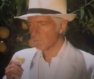 Gurning_Chimp's tweet photo. I don’t know who this bloke is, but he looks like he’s stepped straight out of a different era.  The suit. The hat. The dedication to making sure you get your 5-a-day. The confidence.  A proper throwback to an England that valued character, individuality and a bit of class. https://t.co/0xJee9y2OT