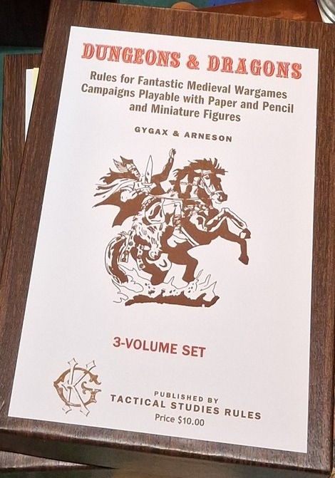 A_DungeonDelver's tweet photo. One post before the D-Day Posting.

I'm auctioning off a single Woodgrain OD&amp;D set reproduction on my Discord channel right now.  Link's at the end of the post.

I'm in a bind, hence the auction rather than the direct sale.

Thank you all in advance.

https://t.co/gSaLYawxLa https://t.co/nZgbyYmL0f