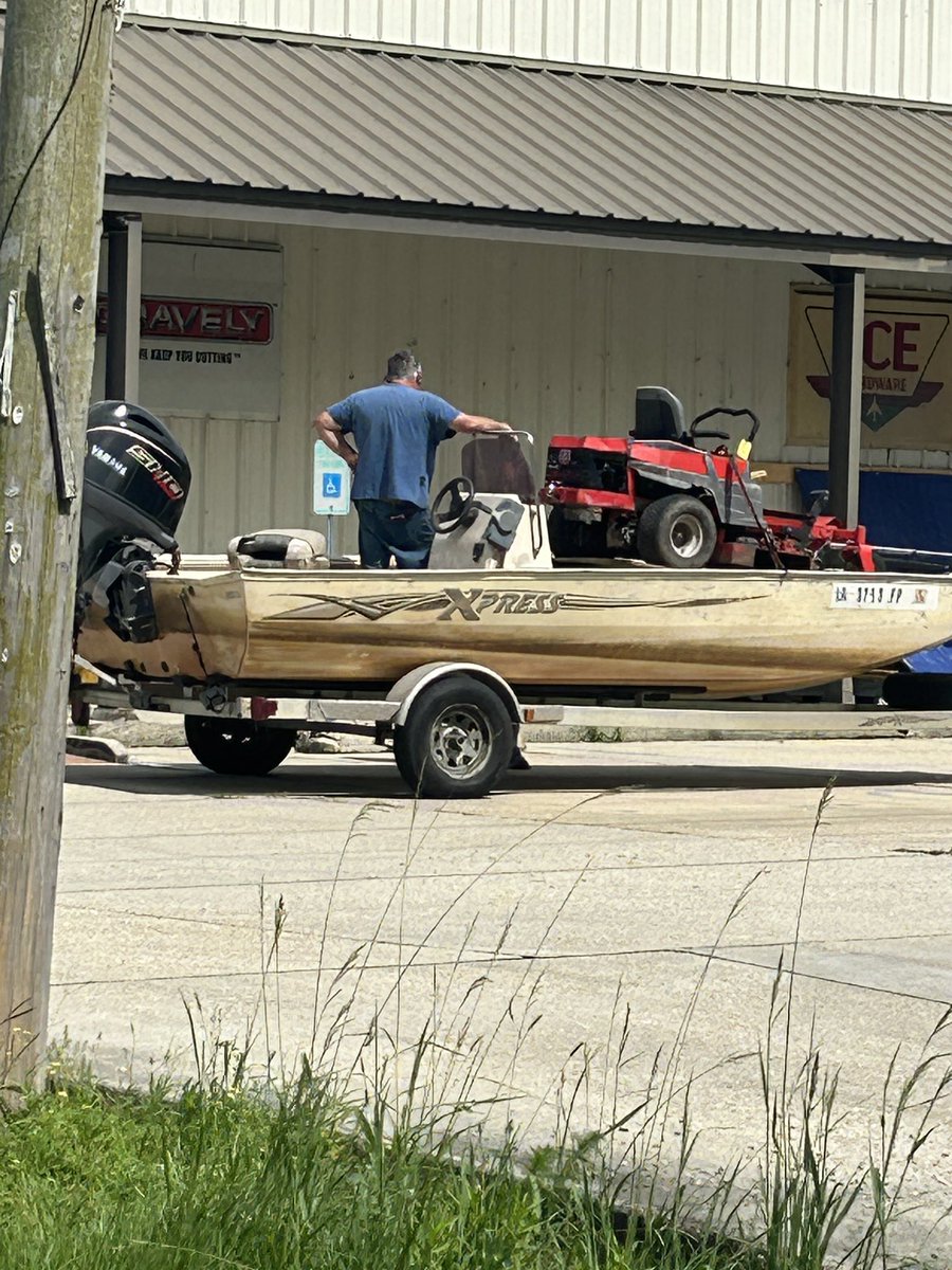 Sanders6353's tweet photo. Tell me you’re from Louisiana, without TELLING me you’re from Louisiana. 

The telling: Lawnmower in the boat, on the trailer.  Attached to the truck at the local hardware store. https://t.co/gu5OoQ47w8