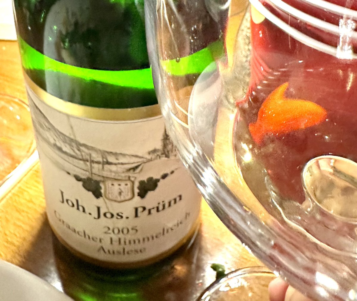 IronChevsky's tweet photo. 2005 J.J. Prüm Graacher Himmelreich Auslese. The best showing I’ve had from J.J. Prüm. I realize this is probably a gross generalization, but in youth I’ve often found Prüm’s wines a bit too dominated by fruit for my personal taste. The quality is obvious, yet I sometimes struggle to see what all the fuss is about. This bottle helped me understand it better.

J.J. Prüm is one of the Mosel’s most revered estates, and Graacher Himmelreich is one of its classic vineyards, known for producing wines that combine delicacy, elegance, and remarkable longevity. Auslese sits above Spätlese in the German ripeness hierarchy and is often viewed as a dessert wine, but the greatest examples can be far more versatile than that.

At 20 years old, this wine still tasted remarkably young. I wouldn’t describe it as especially tertiary, but the exuberant fruit of youth had settled into something more restrained and harmonious. The sweetness felt better integrated, allowing the wine’s balance, minerality, and structure to take center stage.

One of the things I find fascinating about mature Auslese is that it gradually moves beyond the dessert-wine category. The fruit and sweetness remain, but they no longer dominate. Instead, the wine occupies a middle ground between dessert and savory courses. I particularly enjoy aged Auslese with cheese, where the richness, acidity, and sweetness all find a natural balance.

This wine is still remarkably young. It hasn’t yet developed the petrol, smoke, and tertiary complexity that I love in mature Riesling, but for the first time I felt I could clearly see where the wine is headed. If this is what the 2005 looks like at 20 years old, I can only imagine what another decade or two might bring.