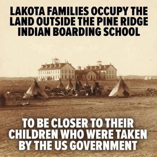 proud_native_am's tweet photo. Imagine being told that your child must leave home… not because they did something wrong, but because the government decided your culture, language, and way of life needed to disappear.

That was the reality for thousands of Native American families.

This haunting image shows Lakota families camped outside the Pine Ridge Indian Boarding School so they could stay as close as possible to their children after they were taken away. Many parents were not allowed to speak their own language to their children. Many children had their hair cut, names changed, and traditions stripped away in an attempt to erase who they were.

Yet the families stayed.

They waited in tents through heat, wind, and cold because love is stronger than fear. Imagine how painful it must have been for mothers and fathers to see their children nearby, but separated by policies designed to break Indigenous identity.

For many Americans, this part of history was never taught in school.

These boarding schools were not just schools. For countless Native families, they became symbols of grief, silence, and cultural loss that still echo through generations today. Survivors have shared heartbreaking stories of loneliness, punishment, and the pain of being told their heritage was something to be ashamed of.

But despite everything, Native communities survived.

Languages survived.

Ceremonies survived.

Traditions survived.

The spirit of the people survived.

And today, more people across America are finally beginning to listen to these stories and recognize the strength of Indigenous families who refused to let their identity disappear.

History is not meant to make us feel comfortable.

It is meant to teach us what should never happen again.

The love of these parents standing outside that school should never be forgotten.

If your child had been taken from you and forbidden from speaking your language or practicing your culture, how far would you go to stay close to them?
