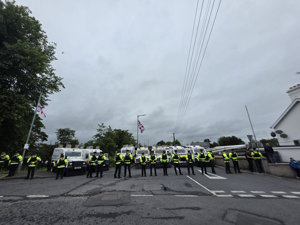krizab's tweet photo. Tension, heavy police presence, helicopters, British and Israeli flags in the small unionist village of Scarva, Northern Ireland, as protestors wait for a pro-Palestinian ‘March for Gaza’ to pass by https://t.co/HyDLP8IGBK