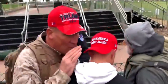 pegchandler's tweet photo. @TomFitton @TPUSA The guy in the light blue cap doesn't seem to belong, Wonder if he's a FED. He raises his fist with a smirk. I'm doubting. Ray Epps revisited? Also with the khaki pants, is that government issue? https://t.co/sNNpT5ZHsL