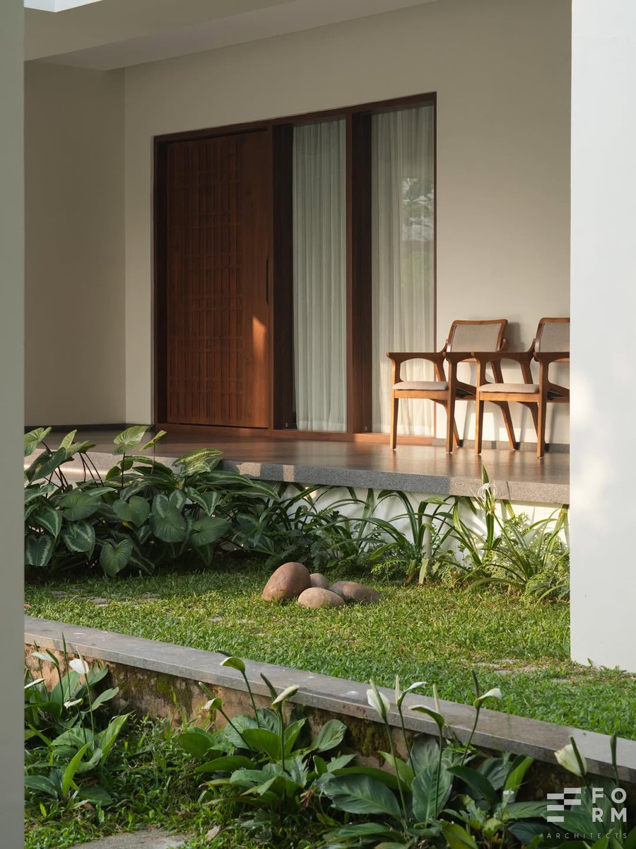 one_miloo's tweet photo. This is what climate-responsive residential design should look like in tropical regions.

- Deep roof overhangs reduce direct heat penetration.
- Vegetation around the building helps cool the surrounding microclimate.
- Large shaded openings improve natural ventilation.
- And the recessed spaces create softer transitions between indoors and outdoors instead of exposing walls directly to harsh sunlight.

In places like Nigeria where heat and unstable electricity are everyday realities, sustainable architecture does not always need expensive technology.

Sometimes, better design decisions alone can make buildings significantly more comfortable to live in.