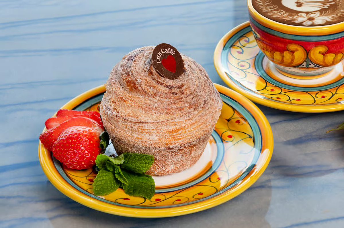 UrthCaffe's tweet photo. Celebrate National Churro Day with Urth’s Churro Delight — a delicious twist on a timeless favorite! This treat features crisp, buttery layers of delicate pastry filled with fragrant vanilla cream, dusted in cinnamon and fine sugar, and crowned with a rich dark chocolate coin. https://t.co/6ftF3Uxem4