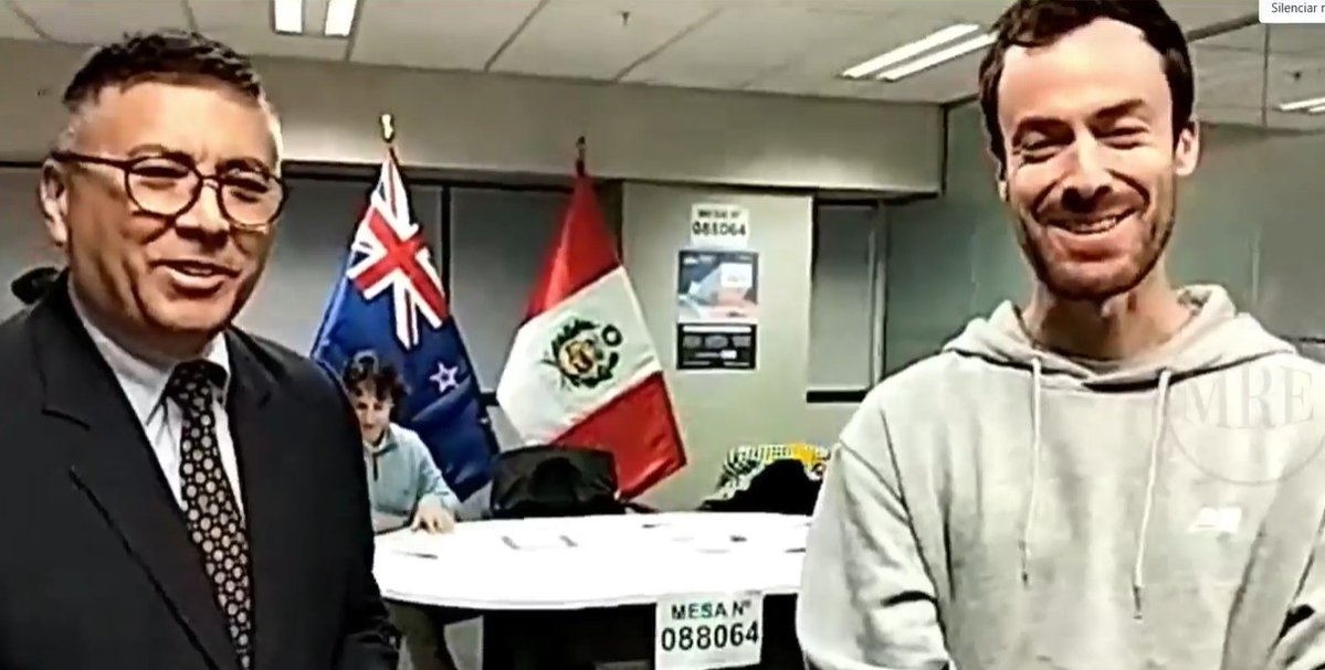 JNE_Peru's tweet photo. Desde Wellington, Nueva Zelanda, se registró el primer ciudadano peruano en votar a nivel mundial en la #SegundaVuelta #EG2026. Él también cumple funciones como presidente de mesa. En la foto junto al embajador de Perú, José Bustinza, quien destacó su gran compromiso cívico. 🗳️✨ https://t.co/tUlSILRT2S