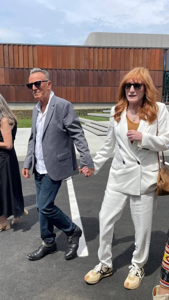 SpringNuts_'s tweet photo. Saturday morning was the dedication and ribbon cutting for the official opening of the Bruce Springsteen Center for American Music in technically Long Branch on the campus of Monmouth University.  

 Bruce Springsteen and his wife Patti Scialfa were at the ceremony along with their son Sam and his wife, Bruce's sisters Ginny and Pam, New Jersey Governor Mikie Sherrill and many other musicians and dignitaries.

 The ceremony took place under a tent in the parking lot of the Center. 
 Bruce spoke last and was very visibly moved. He started his speech saying "Excuse the sunglasses for it's getting a little misty here."
 He said, "I'm also glad and relieved that fans will have another place to go instead of my house."

 He thanked his parents, thanked many at Monmouth University who made this center possible including Eileen Chapman and was emotional as he said, "I got to thank my beautiful wife of 35 years. It's our anniversary (June 9). Without her, so much of this simply would not exist. Her love, her talent, her patience, her support are essential to everything I do and I have done. She is my heart, my soul, she has struggled,  and she is my hero and my favorite E Street Band member." 

He continued, "The mighty E Street Band, who without them, I wouldn't be here. The impact they give me on a nightly basis -- the power, the heart, the soul and complete dedication. ... They deliver for me night after night after night for the past 50 years. Thank you fellas. .... Well this is the wonderful beginning of something that I hope will bring life, hope, creativity education, dreams and inspiration to this campus, our community and our country. I'm deeply honored to be a part of it. Thanks."  

The ceremony in front of about 300 people began at 11 a.m. and was over at 12:30 p.m.
 
Melissa Kozlowski, the Center's director of curatorial affairs, was the emcee. Speakers included Monmouth University President Patrick Leahy; Joy Hargo, the U.S. poet laureate (2019–22); Governor Sherrill, Bob Santelli, the executive director of the Center, and Jon Landau who introduced Bruce.

A formal ribbon cutting then took place to open the Center. 

Among the audience: Jon Bon Jovi, Jackson Browne, Max Weinberg, Garry Tallent, David Sancious, Vini Lopez, Charlie Giordano, George Travis, Ron Aniello, Thom Zimny, Kevin Buell, Lisa Lowell, Rich Russo, Jake Thistle, Erik Flannigan, Jimmie Vaughan, Sonny Kenn, Marc Ribler, Woody Guthrie's daughter Nora, Brian Williams, and photographers Rob DeMartin, Danny Clinch, Eric Meola and Frank Stefanko.   

There was pre-ceremony music by the New Breed Brass Band from New Orleans and during the ceremony, David Sancious played a beautiful version of "New York City Serenade."