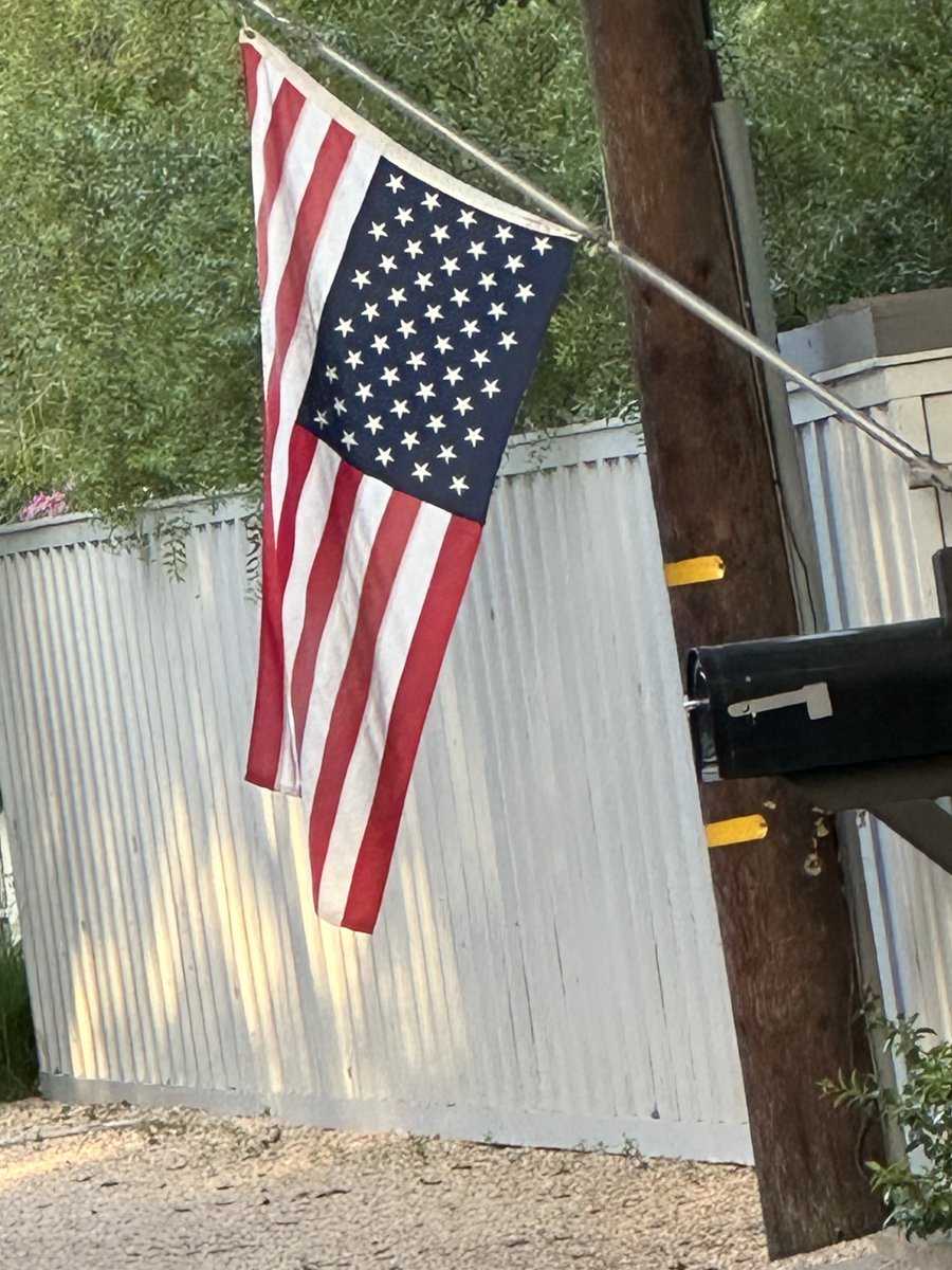 tcboyle's tweet photo. America the Formerly Beautiful. My neighbor is hanging the flag upside down in protest of Trump the Destroyer’s presiding over our 250th. https://t.co/1dK1TNVv7t