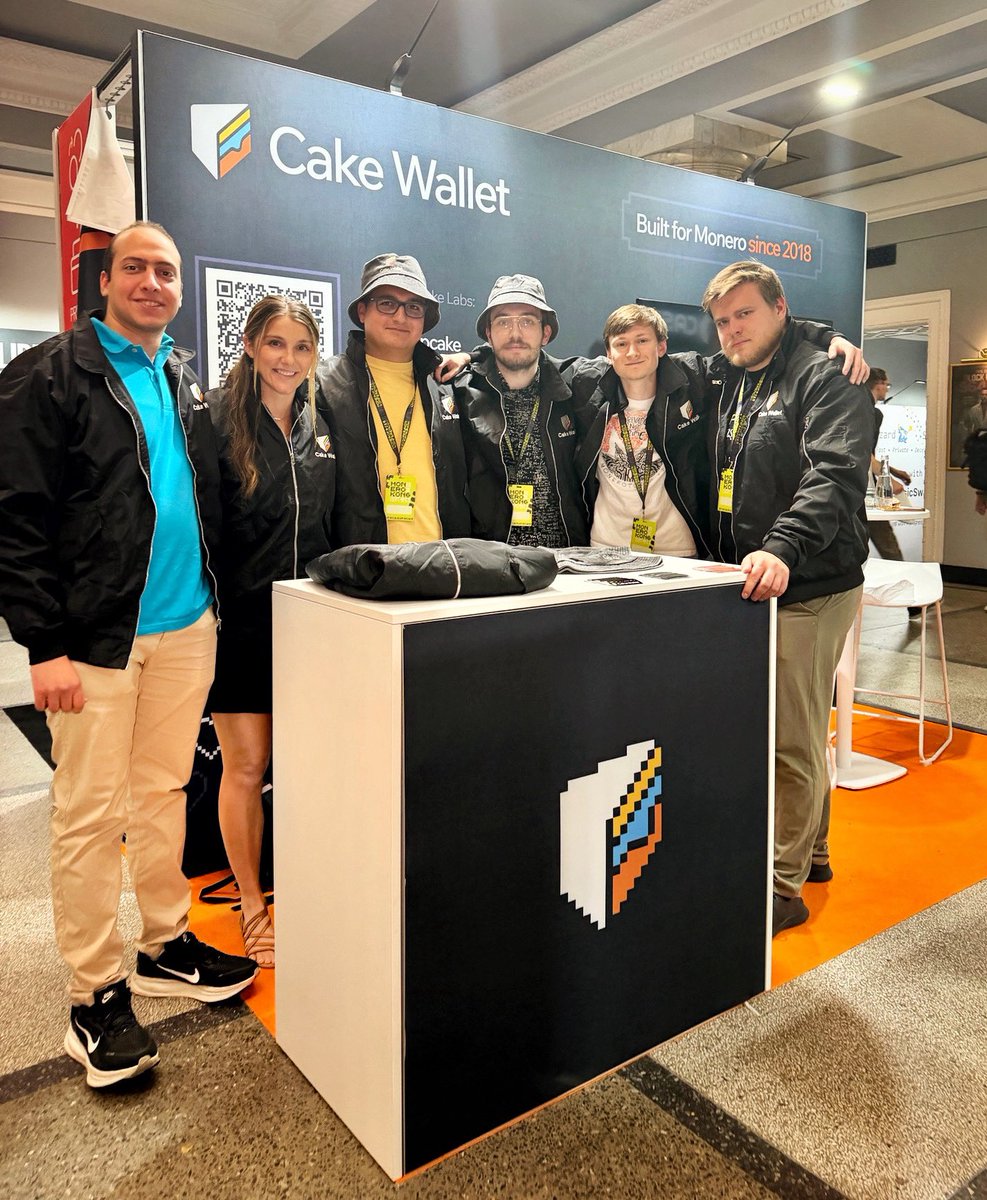 cakewallet's tweet photo. The Cake Wallet crew at @MoneroKon, giving away these sweet hats and jackets! 😎 https://t.co/bmqtu8zxBp