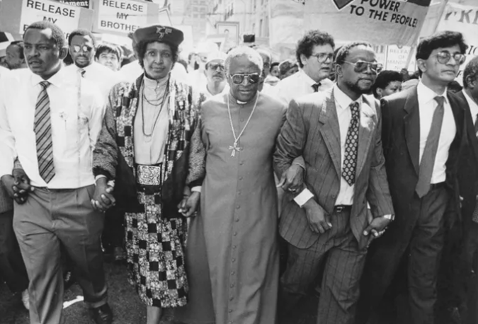 HistorySAZAR's tweet photo. Mosiuoa 'Terror' Lekota, Winnie Madikizela-Mandela, Archbishop Desmond Tutu, Popo Molefe and Mohammed Valli Moosa lead a march in support of the UDF's "Free All Political Prisoners' campaign" in the late 1980s. Source: Independent Media Archives https://t.co/TWI9pLWuGa