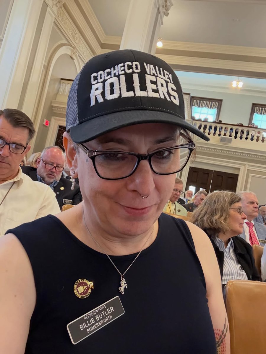 LisaMazurNH's tweet photo. 🔥 SHAMELESS.

NH State Rep Billie Butler (D), a biological male, took to the podium on our last House Session day to lecture everyone that "Pride is a protest." 🚨

He stood at the well wearing an inappropriately short dress and a roller derby cap, displaying zero decorum or respect for the institution he was elected to serve. No pride in representing the people, just grievance theater. 

Meanwhile:

* He uses the women's restroom in the State House.
* He competes in women's roller derby, physically pushing biological women around (he goes by 'Lady Smackbeth').
* Another man in a dress stands behind him nodding along.

This isn't "inclusion." This is the erasure of sex-based rights, fairness in sports, and basic privacy for women and girls.

Time to restore sanity in Concord and our entire state. I'm sick of these men lecturing women about "pride" while erasing our rights and invading our spaces & sports.