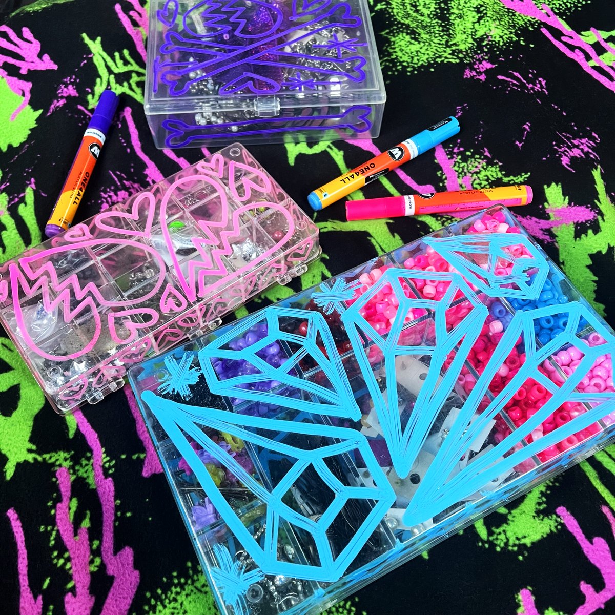 Leannaperry's tweet photo. Illustrated NeonGothTM jewelry organizers featuring neon colored diamonds, broken hearts, bones and stars. Molotow markers on translucent acrylic storage cases. Do it yourself home goods. Surface design 💕💎 https://t.co/MDnOsNbPNg