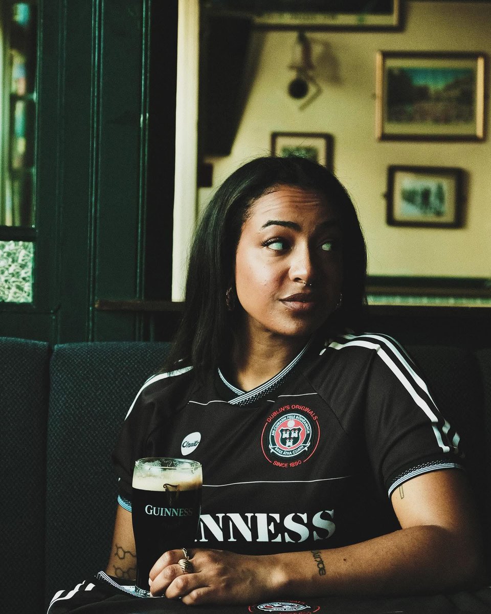 IFBMedia's tweet photo. The Bohemian Blueprint 🔴⚫

Did you know the Bohs 1976 FAI Cup winning side was the first sponsored kit in Ireland and Britain?

And that pioneering nature has continued into 2026!

The reason Bohs can tell these stories is the ground they tell them from. Dalymount Park, the old home of Irish football, was also the cultural heart of the city.

Years before Croke Park, Marlay Park or the Phoenix Park, Dalymount was the only major venue in Dublin hosting outdoor concerts.

Thin Lizzy headlined Dublin’s first major open air rock festival there on 21 August 1977, the day after Phil Lynott’s 28th birthday, with the Boomtown Rats and the Radiators From Space on the bill. Three years later, on 6 July 1980, Bob Marley played his last ever outdoor concert on the same pitch.

Decades later, the club started turning that heritage into shirts. And they did it with purpose.

It began in 2018 with a Bob Marley away kit. Pre-orders flew in from 45 countries and Marley’s son called it “the dopest shirt I’ve ever seen”, before the image rights collapsed and it was scrapped. They replaced his face with a clenched fist. The idea never died.

In 2020 they put “Refugees Welcome” across the front in place of a sponsor, partnered with Amnesty International, with a fleeing family on the body and “Love Football, Hate Racism” on the collar. It sold in 23 countries.

2021 brought Fontaines D.C. and Focus Ireland, 15% of profits going to tackle homelessness. In 2022 they landed the Bob Marley shirt properly, working with the Marley family directly, 10% of profits buying instruments and equipment for asylum seekers in Ireland.

For 2024 they honoured that Thin Lizzy gig with black rose artwork by Jim Fitzpatrick, funding music education for disadvantaged Dublin kids. Then 2025, Fontaines D.C. again, 30% of profits going to Medical Aid for Palestinians.

Every shirt a story. Every release a purpose.

Where so many clubs are hollow brands, soulless crests and corporate spin with no real connection to the people they claim to represent, Bohemian FC are the antidote.

They know who they are, where they come from, and what they stand for.

And they wear it, quite literally, on their sleeves. 🔴⚫