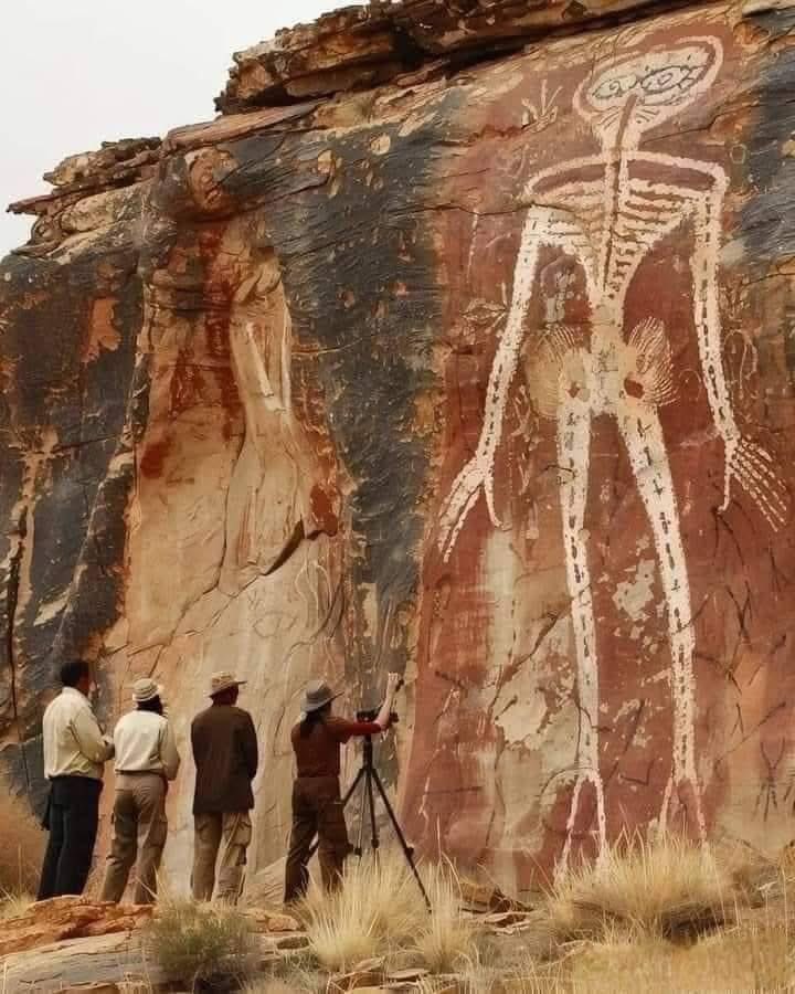 UnearthedHQ's tweet photo. This Giant Figure Has Been Standing Here for Thousands of Years… But No One Knows Why

Deep in a remote desert canyon, a massive white skeleton-like figure is carved into the rock. No signs, no barriers — just this huge, silent image watching over the land.

It wasn’t made recently. It’s ancient. Thousands of years old.

Think about that.

Long before modern cities, before cameras, before written history as we know it — someone stood here and created this. Not small, not hidden… but something this big, this bold. Something meant to be seen.

In the photo, a few researchers stand in front of it. They look tiny. Almost nothing compared to the scale of the figure behind them. One of them sets up a camera, trying to capture it… but being there in person must feel completely different.

Because this isn’t just art.

It’s a question.

Who made it? What did it mean to them? And why choose a skeleton-like shape?

The desert has changed over time. Civilizations came and went. But this figure is still here — untouched, unmoving, and unexplained.

And maybe that’s what makes it so powerful.

Not everything from the past wants to be understood.