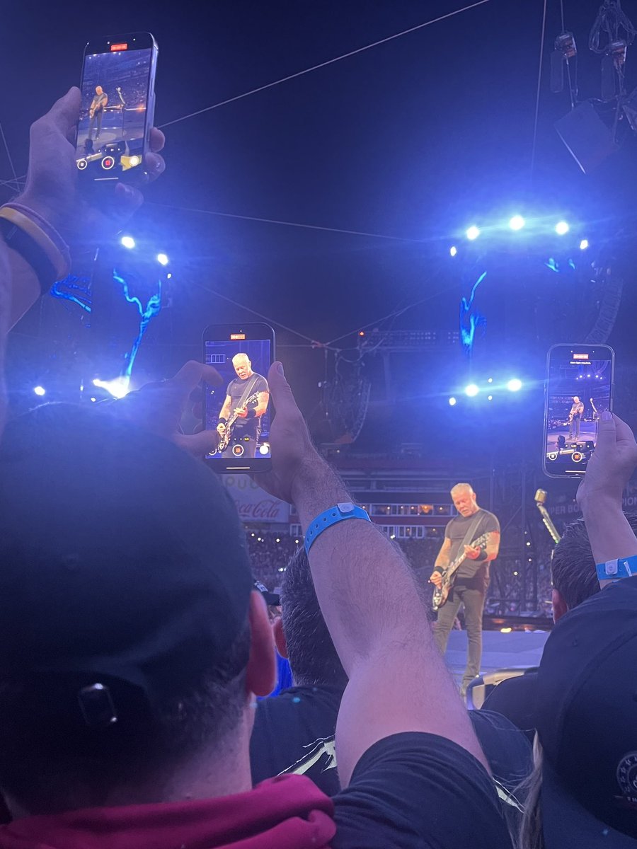 Schnelkc's tweet photo. @bradluttrell Generally not a fan of a phone policy for most shows I go to (alt country).  However, the Metallica show was different &amp; awful.  This is a pic I took of my “view” I had the entire concert and these 3 were just an example of what 40% of the crowd was doing the entire show. 👎👎👎 https://t.co/1shzTKNV5T