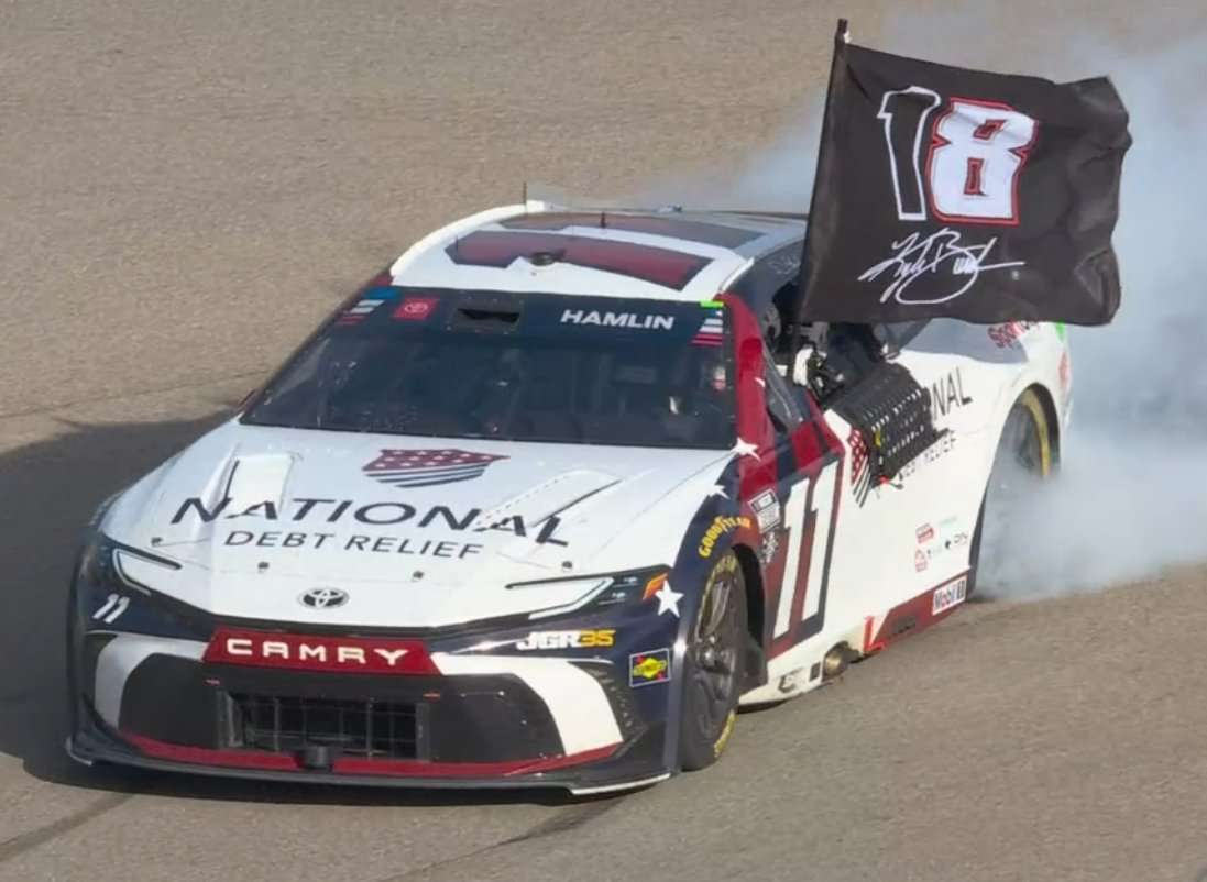 STaranto92's tweet photo. One of Denny Hamlin's crewmembers ran out an 18 flag - a combination of Kyle Busch's number at Joe Gibbs Racing and the 8 he ran in recent years - to Hamlin after the checkered flag. 

Hamlin took the flag, turned backwards down the frontstretch, and then did his burnout before holding the flag aloft after he climbed out of his car in honor of his longtime teammate, who he now ties for ninth on NASCAR's all-time Cup wins list with 63.

Hamlin also made mention of Ned Jarrett, the original star driver of the No. 11, who passed away Thursday at the age of 93.