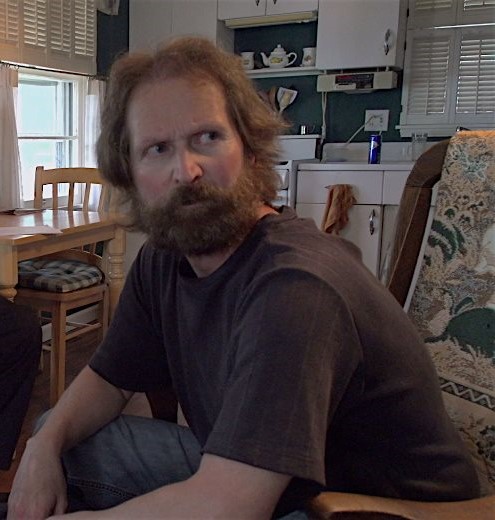 GlennBerggoetz's tweet photo. This is a still from the comedy feature film "Poetry Slammed" that I co-starred in, playing a bitter, burned-out poet.  That's my actual hair and beard!  Stream "Poetry Slammed" at https://t.co/RQJF2U2i3D https://t.co/h39EwNGUFx