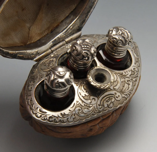 wikivictorian's tweet photo. Hinged walnut case with three scent bottles and a funnel, 19th century. France. In private collection. https://t.co/p4iOLRV71v