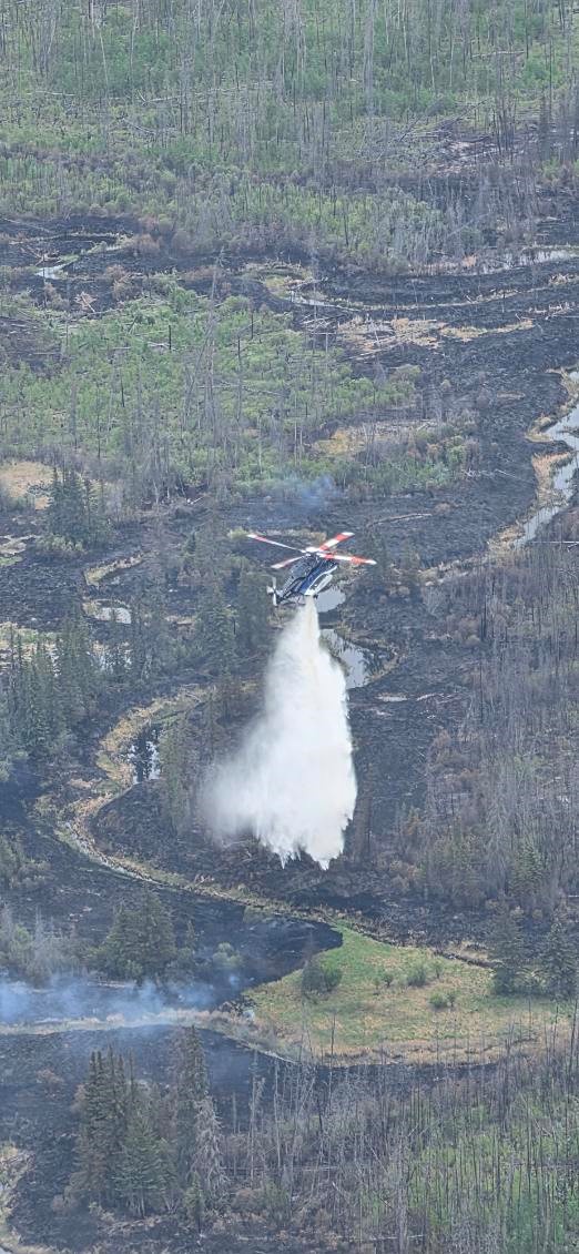 NWTFire's tweet photo. WILDFIRE UPDATE – June 8, 2026 – 3:30pm: No new fires.

Weather:
Areas across the territory will continue to experience a downward trend in weather over the next few days. Most notably, showers are expected in the SE area of the NWT, including WBNP. 

Temperatures are expected to rise later in the week. Moderate fire danger throughout the southern regions, with high fire danger in Wood Buffalo National Park.

➡️South Slave:
Klewi Complex (2026WB004, 2026WB009, SS004-26 | Wood Buffalo National Park fires): The current fire danger level for Wood Buffalo National Park is high. This fire size has been reassessed and is estimated at 52,966 hectares and is classified as out of control.

This fire is on the northeastern side of Wood Buffalo National Park near the Whooping Crane nesting area, approximately 22 km northeast of Highway 5

The Government of Northwest Territories continues to provide mutual aid through airtanker and helicopter support, and wildfire crews are now deployed to the park to assist. For details on these fires and actions to manage them, and weather updates visit: https://t.co/jrN8EcvhZV 

Aircraft and crews were challenged by low ceilings today and were unable to safely transport firefighters by helicopter to the fire. Crews stayed productive in camp, cleaning and maintaining equipment, ready to get back to the fire tomorrow if the weather allows.

Parks Canada and the GNWT will continue to work under a unified command with the objective of reducing the fires’ growth toward the communities of Fort Resolution and Little Buffalo

Sprinklers continue to be maintained on values at Grande Détour and north of Salt River by GNWT wildfire management staff as a precaution. 

Current Resources: 176 personnel, 15 helicopters and 6 fuel bowsers.

There is no risk to communities, infrastructure or cabins at this time. 
---
Report new fires to 1-877-NWT-FIRE (698-3473).

Follow us here or visit https://t.co/MtvTM0ofro for the latest – or give an on-call Fire Information Officer a shout at 867-445-5484 if you prefer. 

📸: Firefighters and aircraft making good progress on the Klewi Complex fire in WBNP on June 7, 2026.