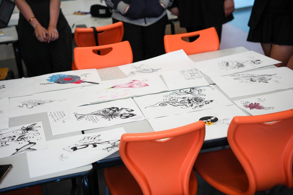JayTAT2's tweet photo. Yesterday morning, I had the pleasure of being invited by @LFCFoundation to Holly Lodge Girls' College in Liverpool to speak to a group of art students, aged 15–18, about tattooing and my path into the profession. 

When I was their age, there was no chance you would have seen a tattoo artist standing in a school, talking to students about tattooing as a potential career path. Back then, tattooing wasn't viewed as the art form it is today.
So, to be standing in a school yesterday, shining a light on the profession I love, sharing my experiences, and encouraging such a talented group of young artists to follow their passions was incredibly special for me. 

As part of the session, I gave the students a brief from a fictional client and asked them to create a tattoo design based on it. The creativity, imagination, and thought that went into their work was great to see, and I enjoyed watching them bring their ideas to life. 

A huge well done to all of these talented young ladies who have bright futures ahead in whatever they do. 

Thank you to the art department for being so open to tattooing being discussed in an educational setting, and of course, thank you to the LFC Foundation for inviting me back to work alongside them once again. 

YNWA ❤️