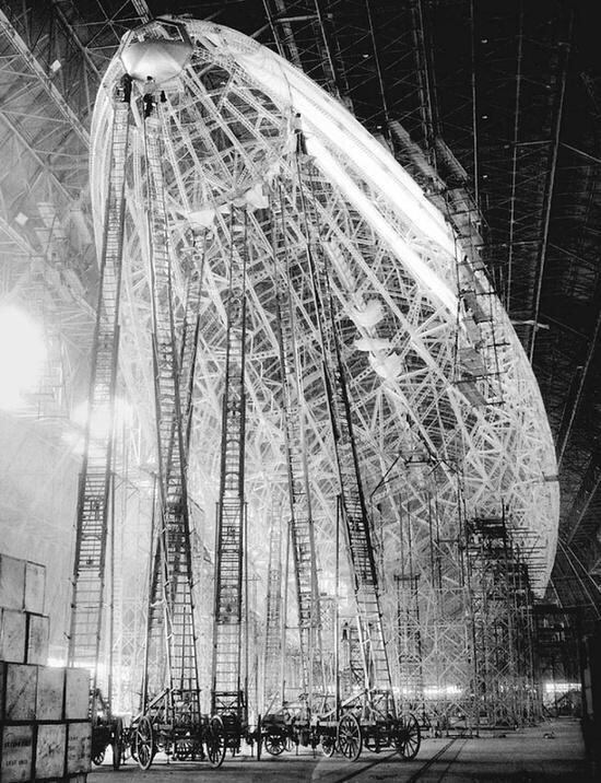 LaocoonofTroy's tweet photo. A Zeppelin under construction in 1930s Germany. Notice the men working on top of the giant ladders. https://t.co/bJb9vpM2sJ