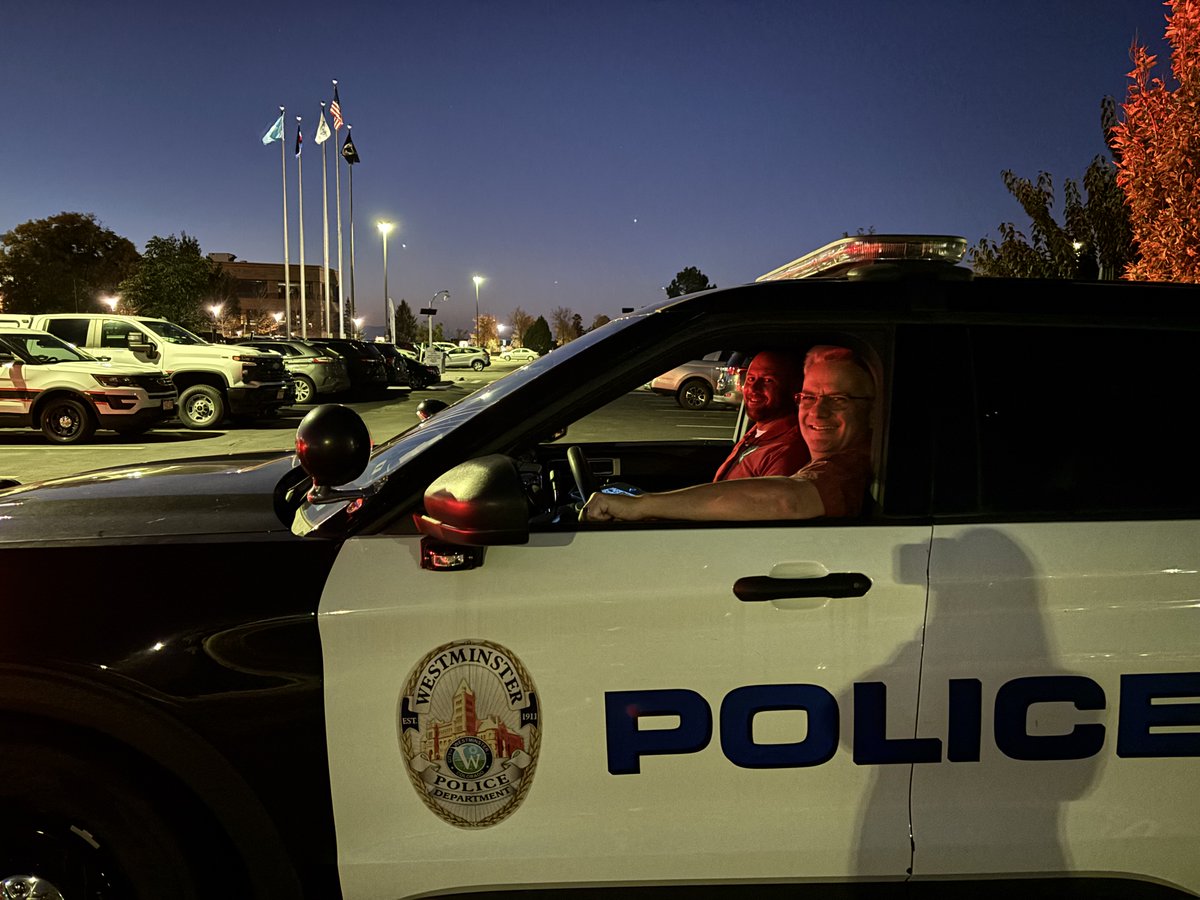 Two people inside a police vehicle.